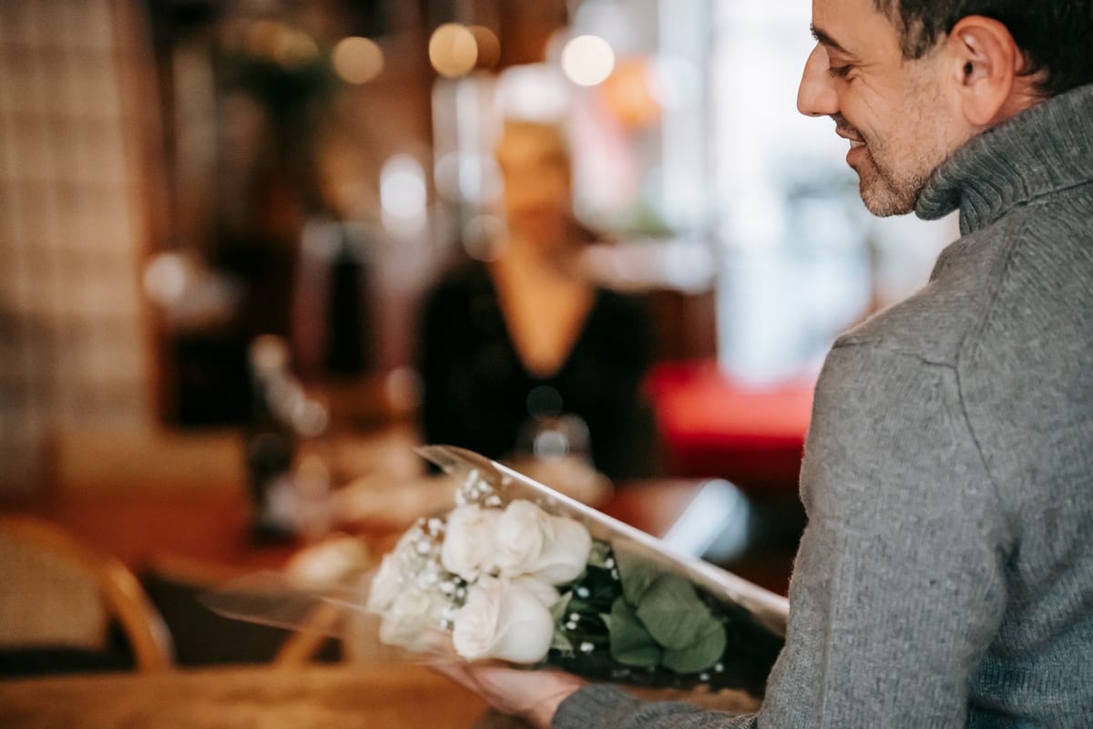 The best anniversary gifts for 2026 with roses and a wrapped present