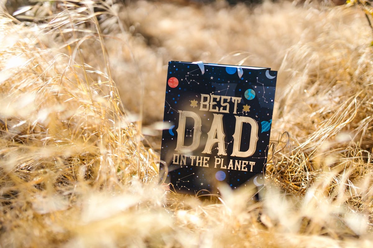 A Father's Day gift box beside a handwritten card