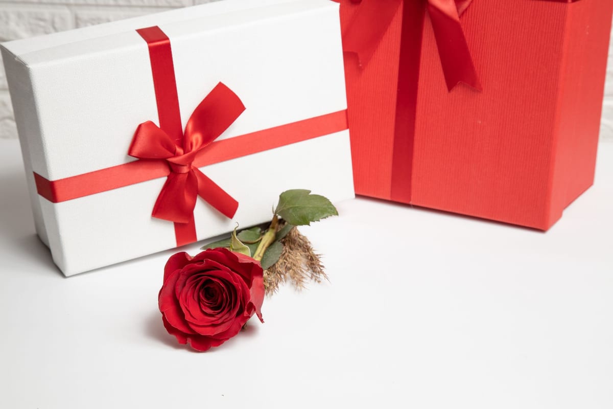 A romantic gift for her with roses and a wrapped present